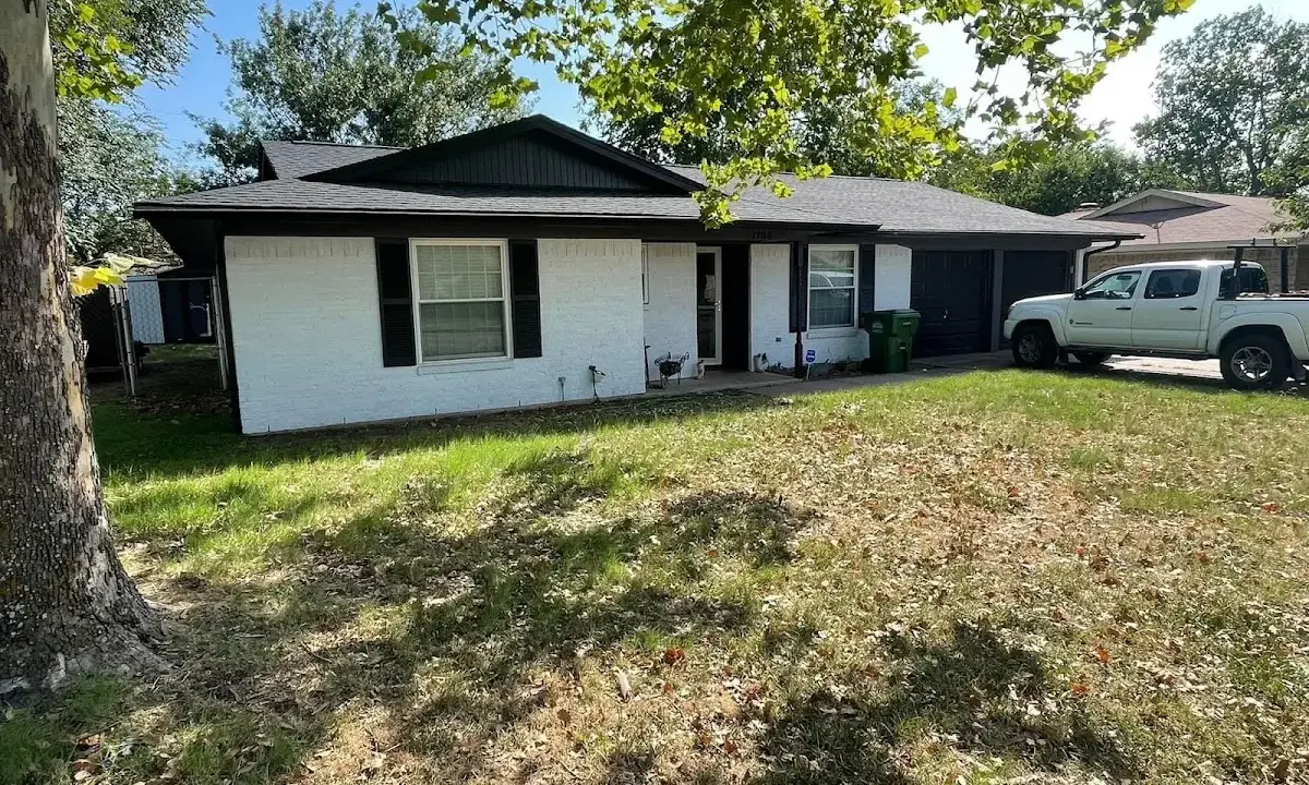 Professional roofing crew working on a residential roof in West Livingston